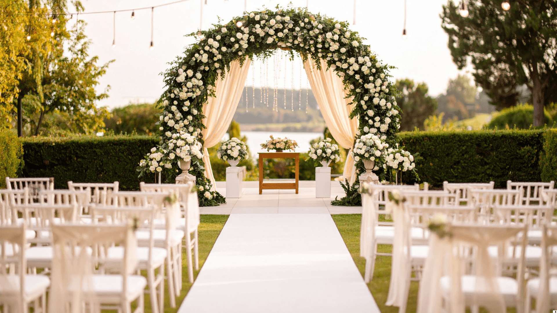Outdoor wedding ceremony with floral arch