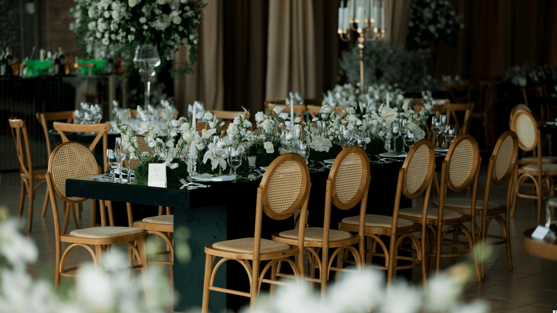 Dark and elegant dinner table with white florals