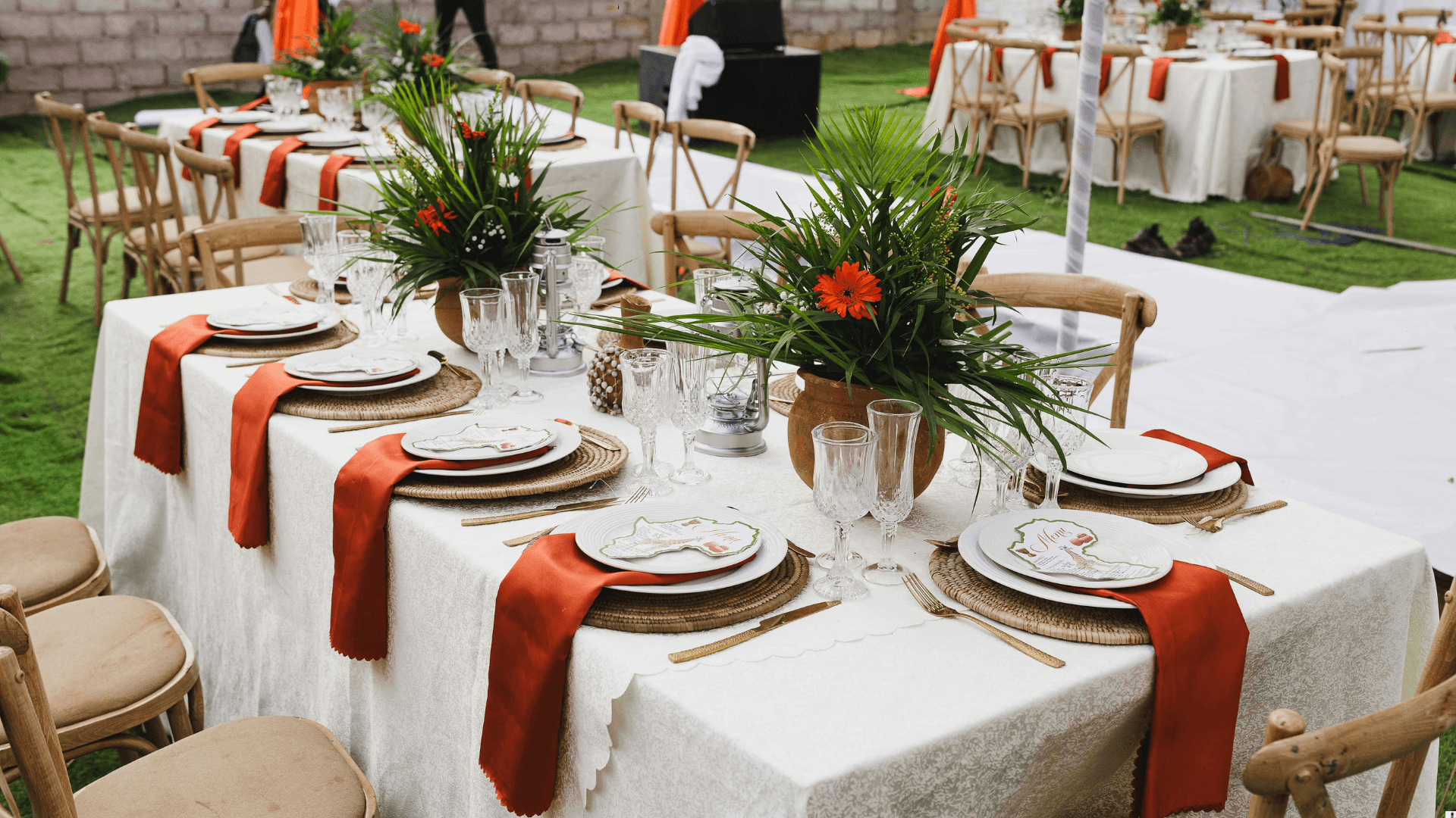 Outdoor tropical table setting with orange florals