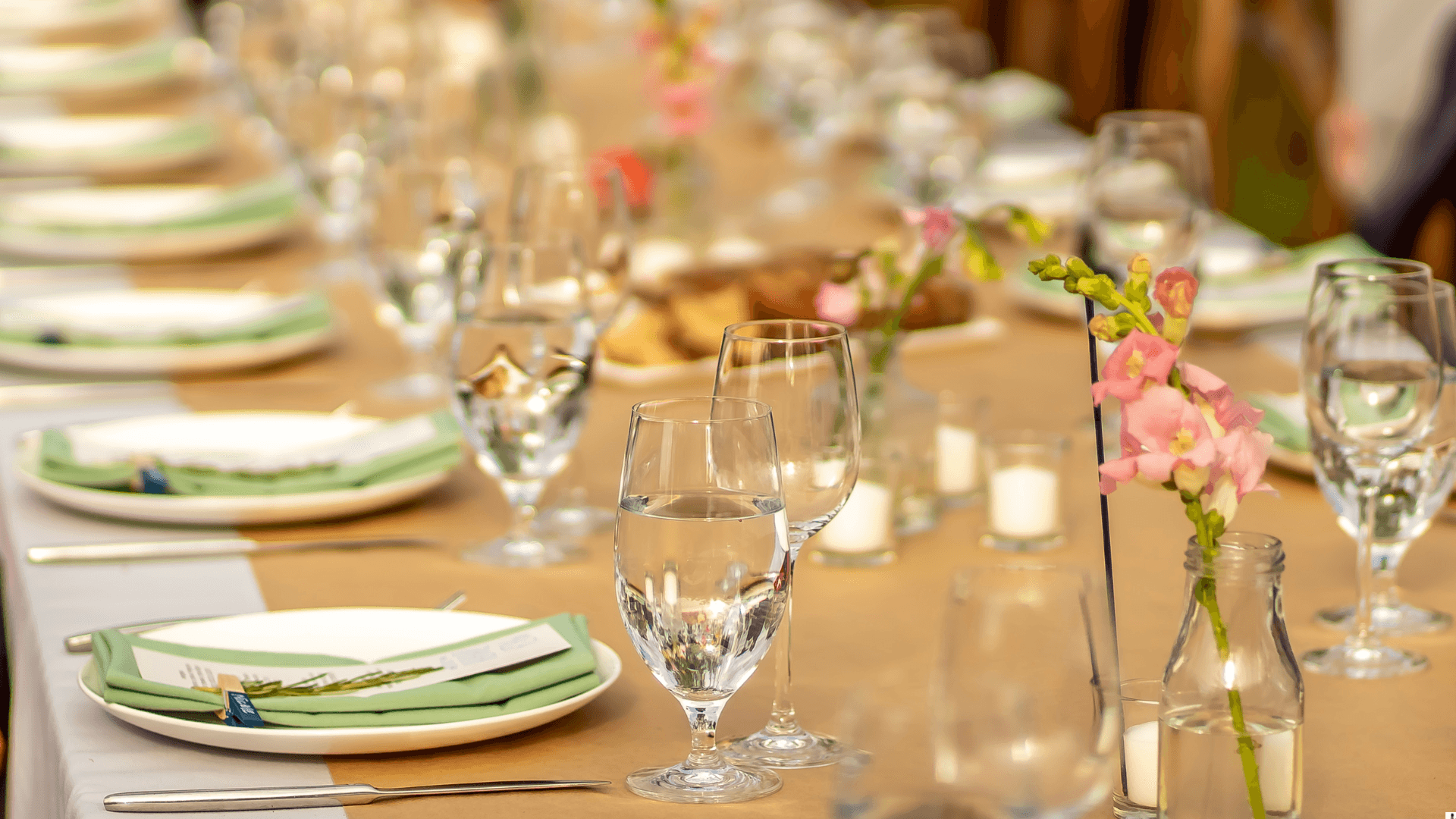 Long banquet table with flower centrepieces