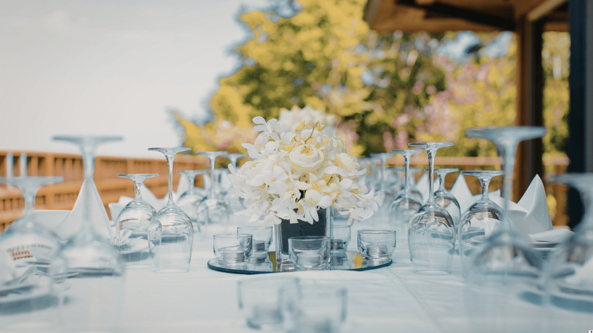 Outdoor table setting with white flower centrepiece