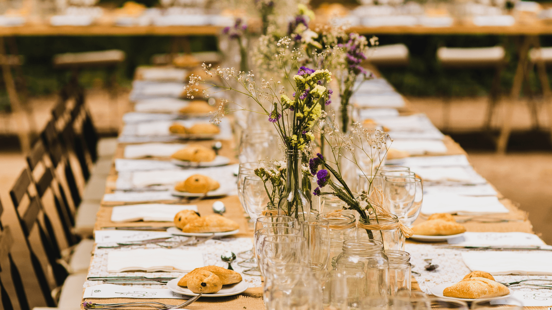 Rustic outdoor banquet with wildflower centrepieces
