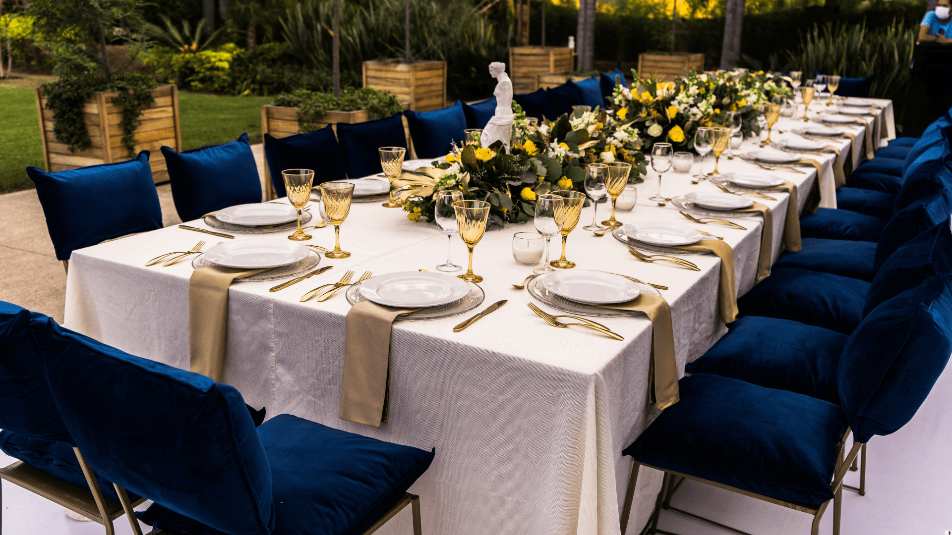 Outdoor long table with blue velvet chairs