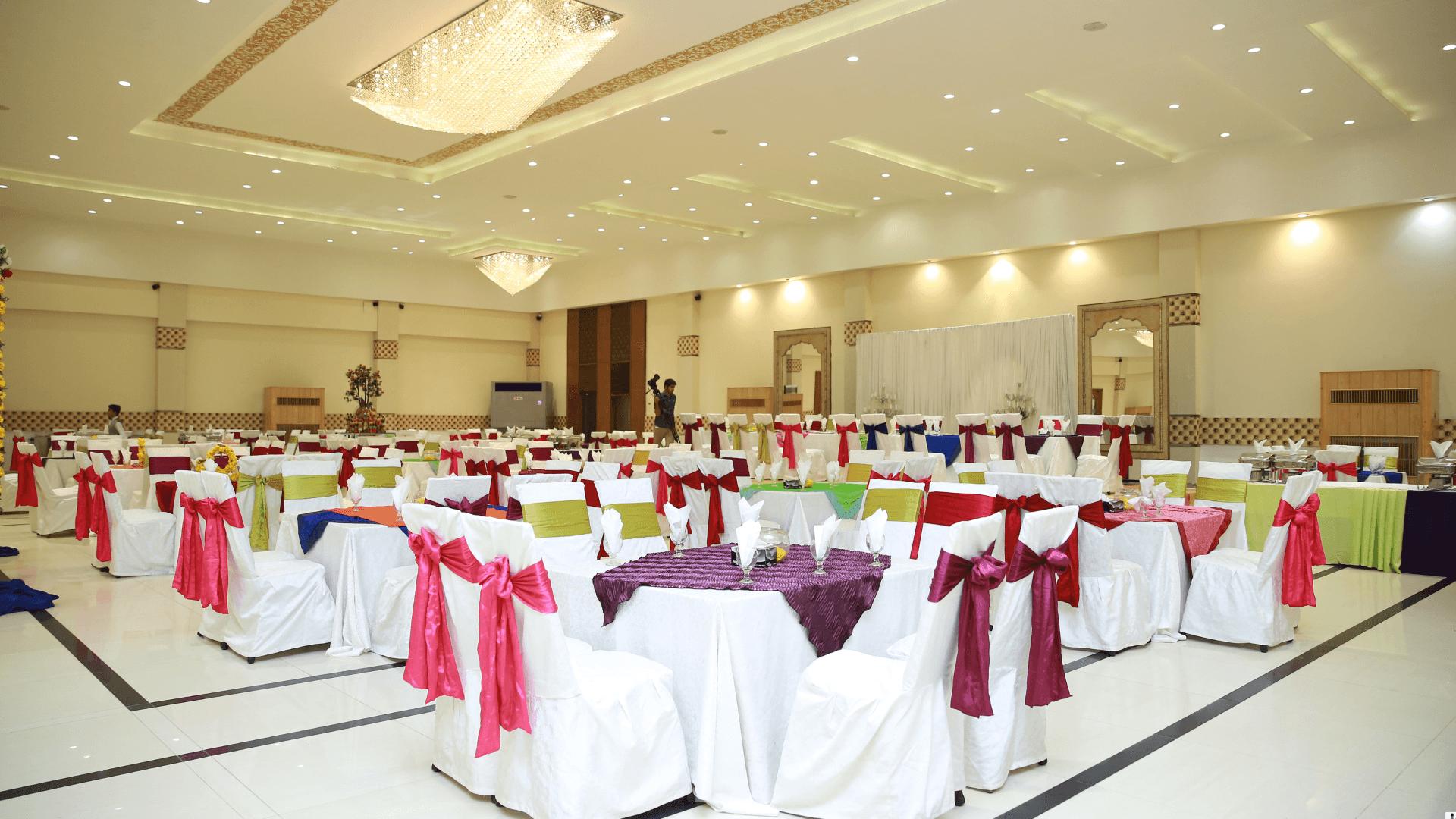 Large banquet hall with colourful chair sashes