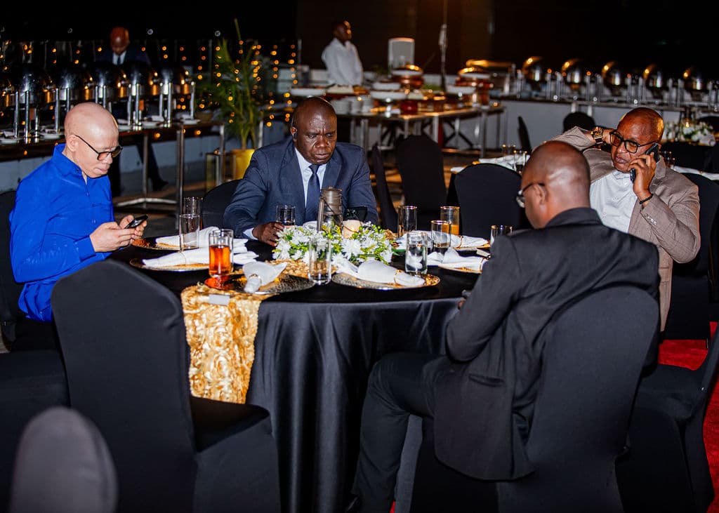 Guests chatting beside the buffet stations at the gala dinner