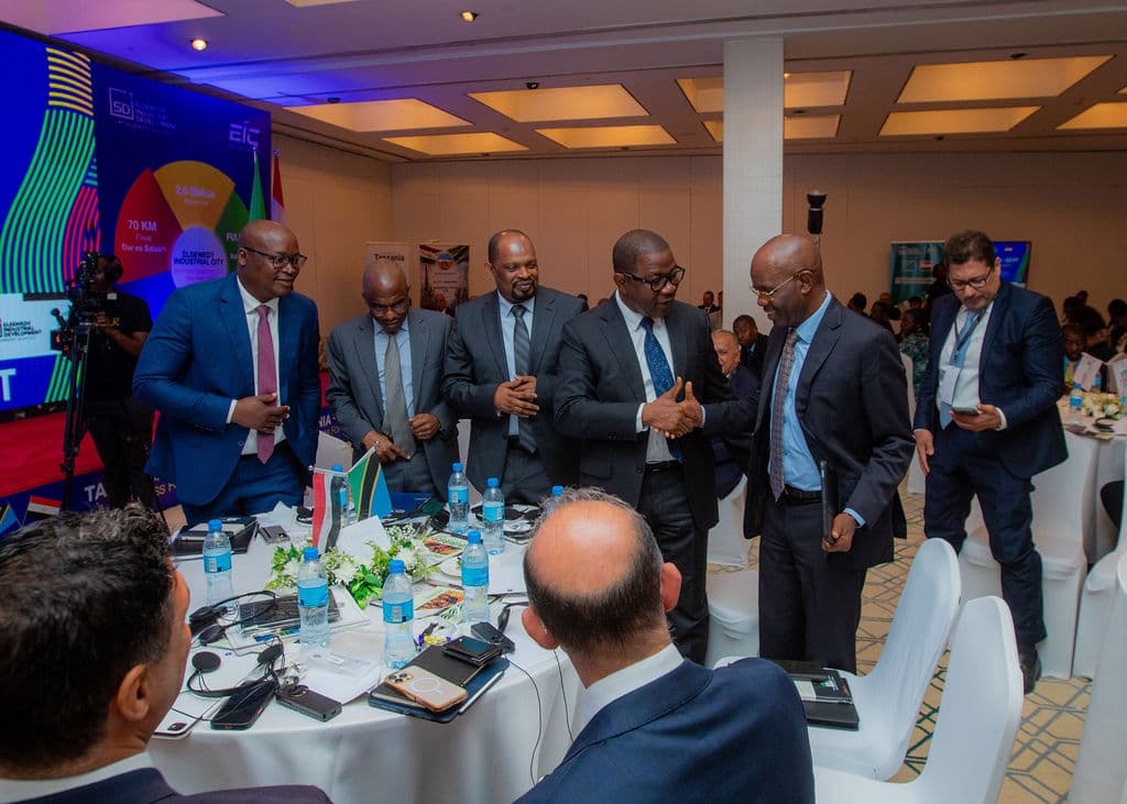 Group of business delegates greeting each other beside a round table