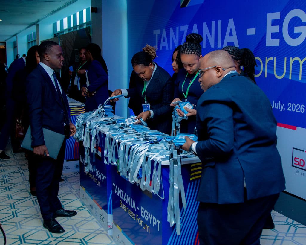 Staff organising delegate lanyards at the forum registration desk